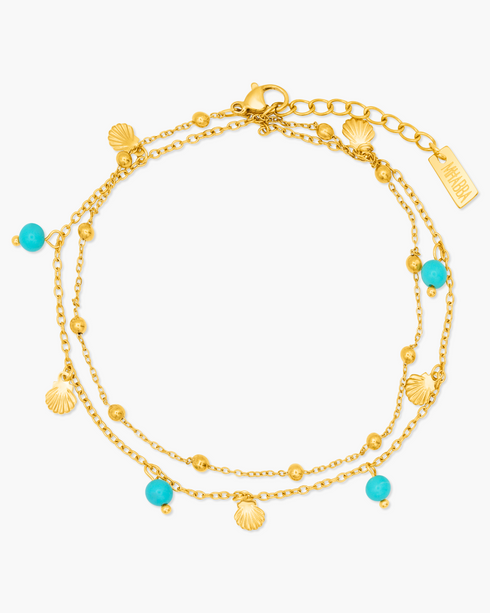 Gold anklet with turquoise beads on a white background